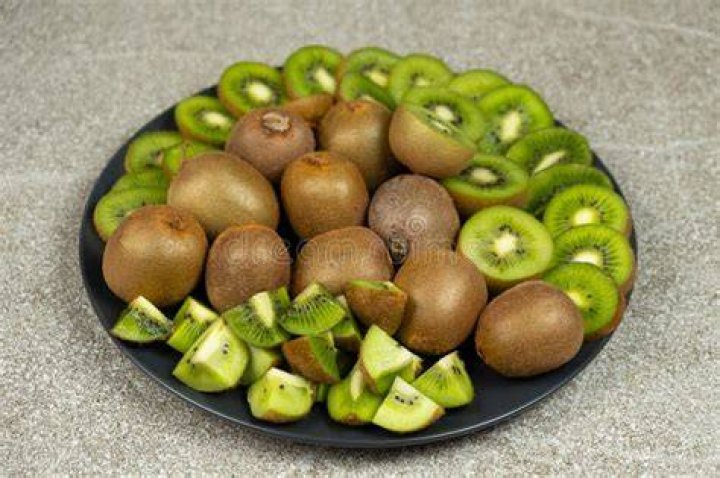 Sliced kiwi sliced fresh kiwi fruit on wood table
