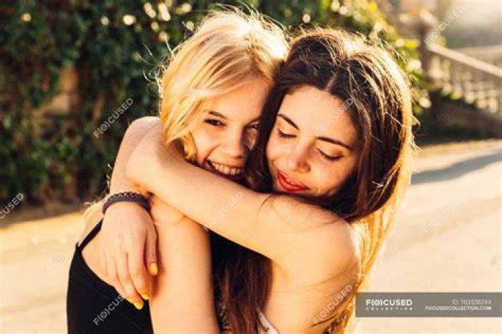 Two moroccan girls hugging and smiling